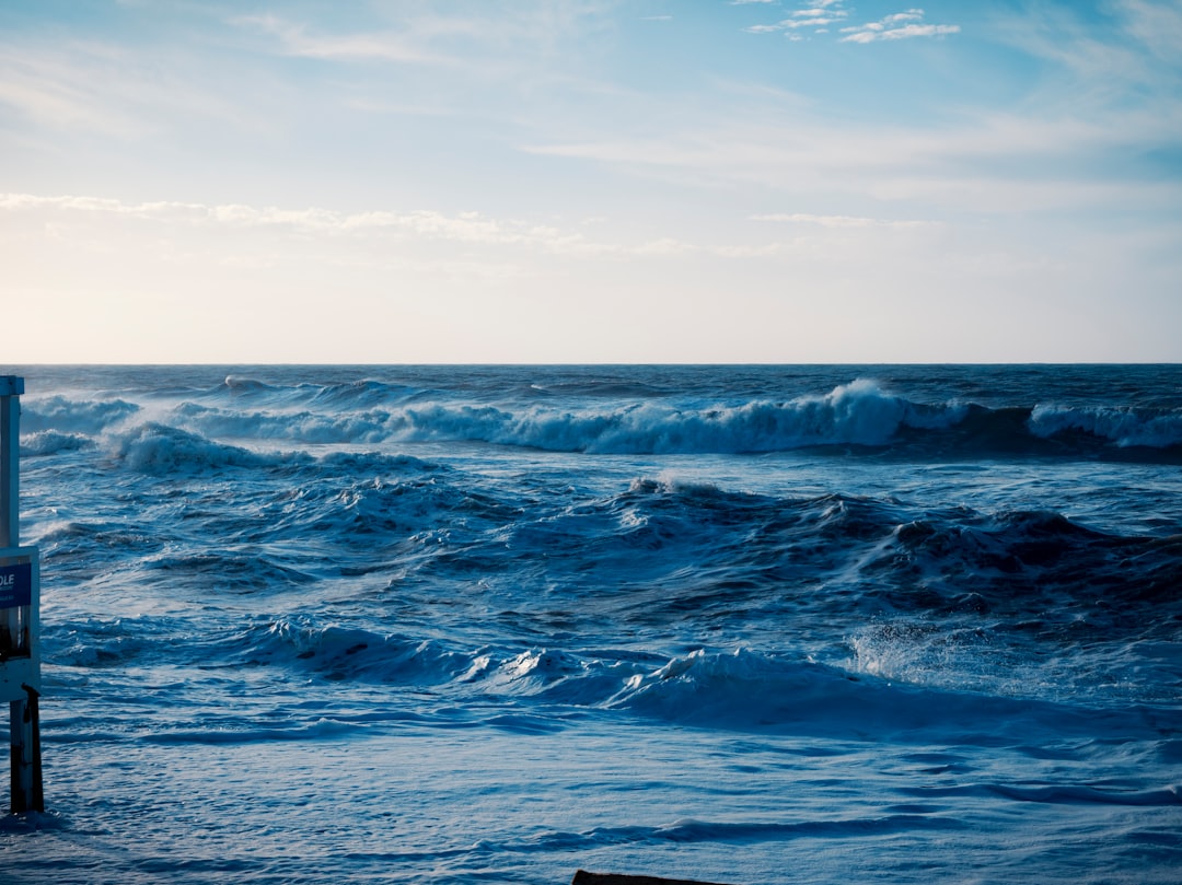 Crashing ocean waves under a cloudy sky